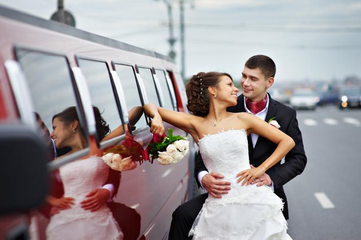 Bride & groom next to their Hummer Limousine.